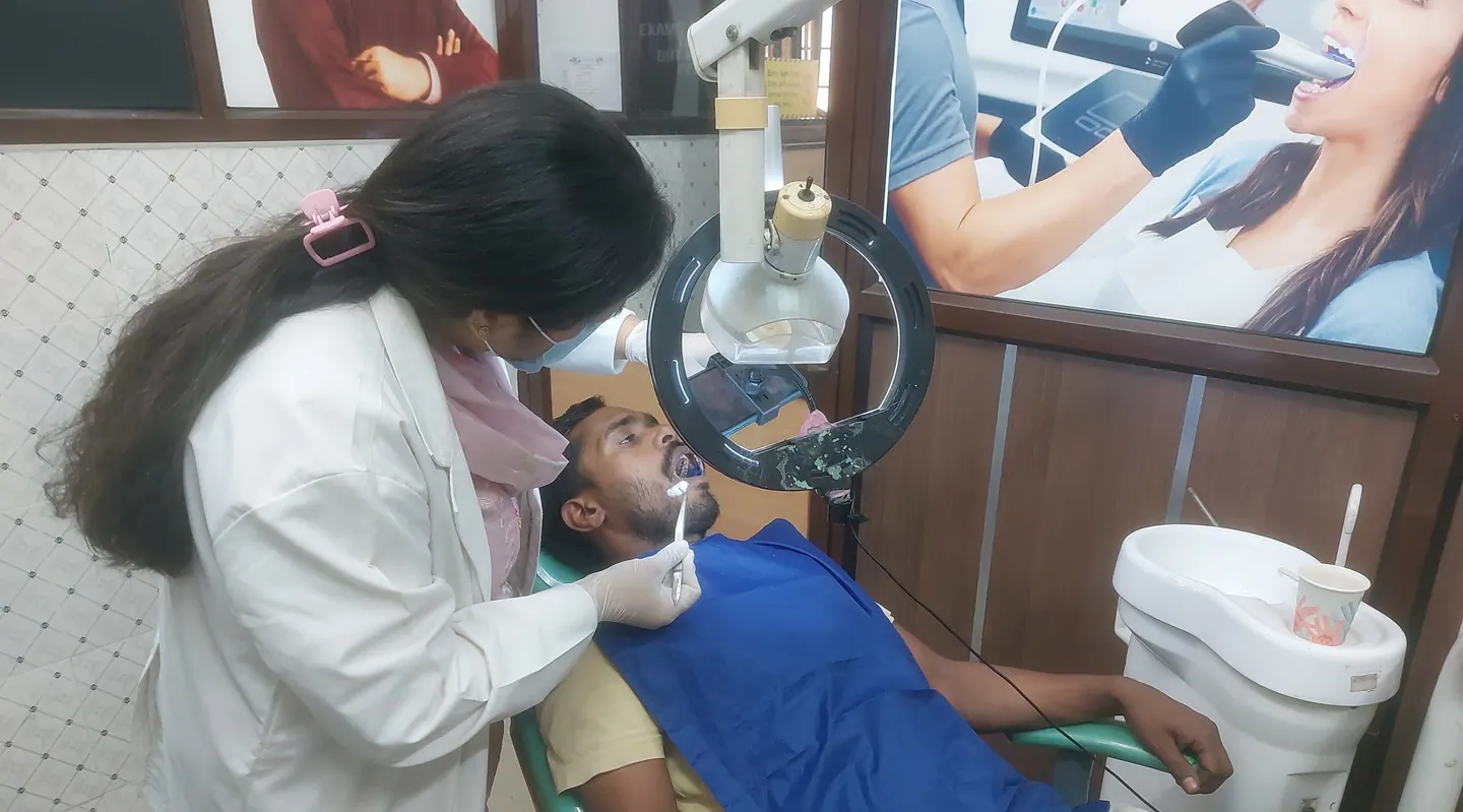 A dentist examining a patient in the dental hospital